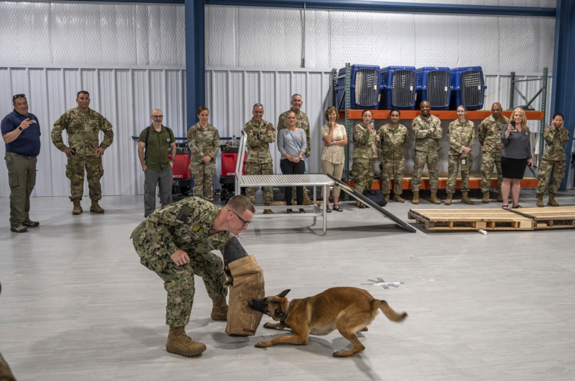 U.S. Air Force Gen. John E. Hyten and SEAC Ramón "CZ" Colón-López, along with members and entertainers, watch a military working dog demonstration at JBSA-Lackland.