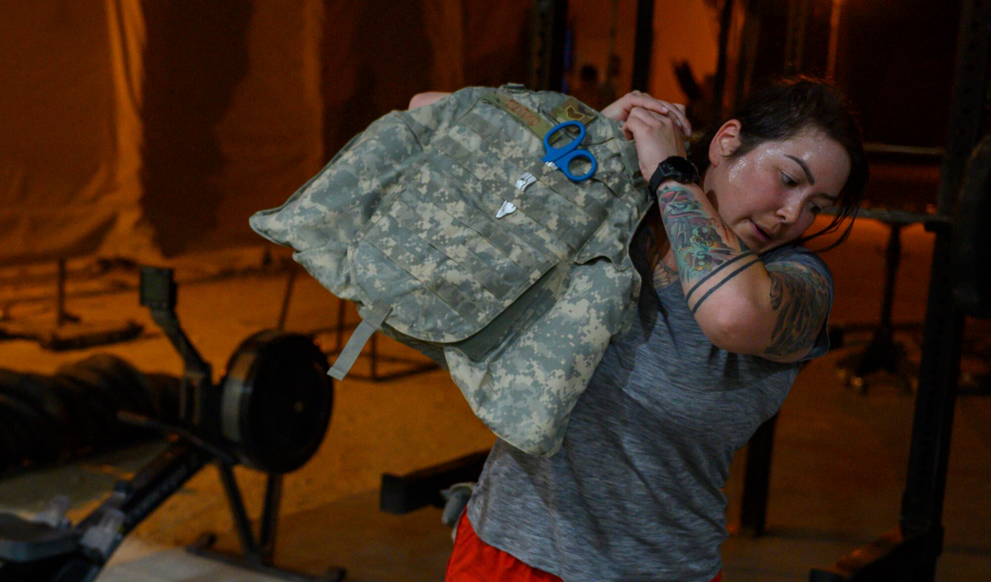 U.S. Air Force Staff Sgt. Kelly Dzitko, 378th Expeditionary Medical Squadron respiratory therapist, puts on personal protection equipment during the first best medic competition at Prince Sultan Air Base, June 21, 2021.  The competition was a culmination of the past 11 weeks of combat medicine training, testing their ability to provide care in unexpected situations.  (U.S. Air Force photo by Senior Airman Samuel Earick)