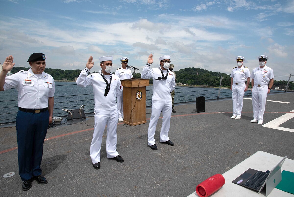 Sailors participate in a naturalization ceremony.