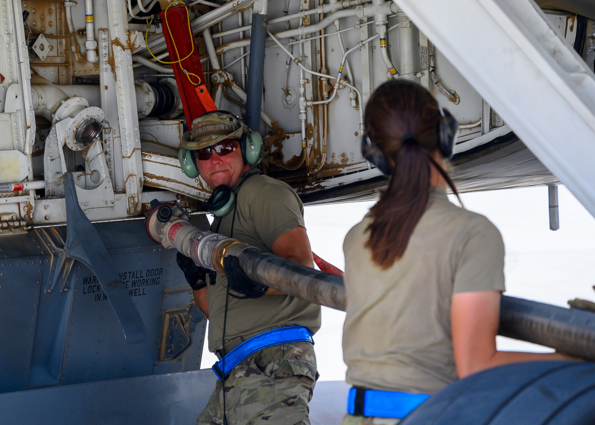 U.S. Air Force Tech. Sgt. Adam Barrett, 157th Expeditionary Fighter Generation Squadron F-16 dedicated crew chief, prepares a fuel hose to conduct a hot pit refueling on a U.S. Air Force KC-135 Stratotanker, Prince Sultan Air Base, June 25, 2021. This event demonstrated the success of several weeks of hot-pit refueling cross-airframe training between 378th and 379th Air Expeditionary Wing maintainers, expanding both Wings ability to provide agile support for theater operations. (U.S. Air Force photo by Senior Airman Samuel Earick)