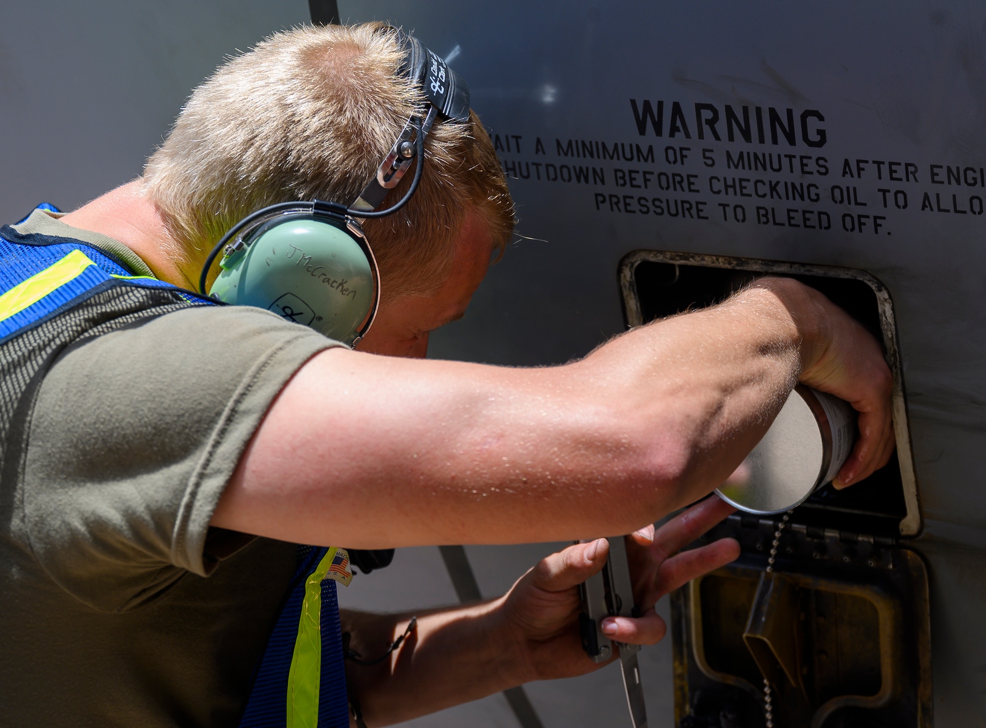 U.S. Senior Airman Jacob McCraken, 157th Expeditionary Fighter Generation Squadron assistant dedicated crew chief, applies oil to a U.S. Air Force KC-135 Stratotanker during a hot-pit refueling, Prince Sultan Air Base, June 25, 2021 This event demonstrated the success of several weeks of hot pit cross-airframe training between 378th and 379th Air Expeditionary Wing maintainers, expanding both wings ability to provide agile support for theater operations. (U.S. Air Force photo by Senior Airman Samuel Earick)