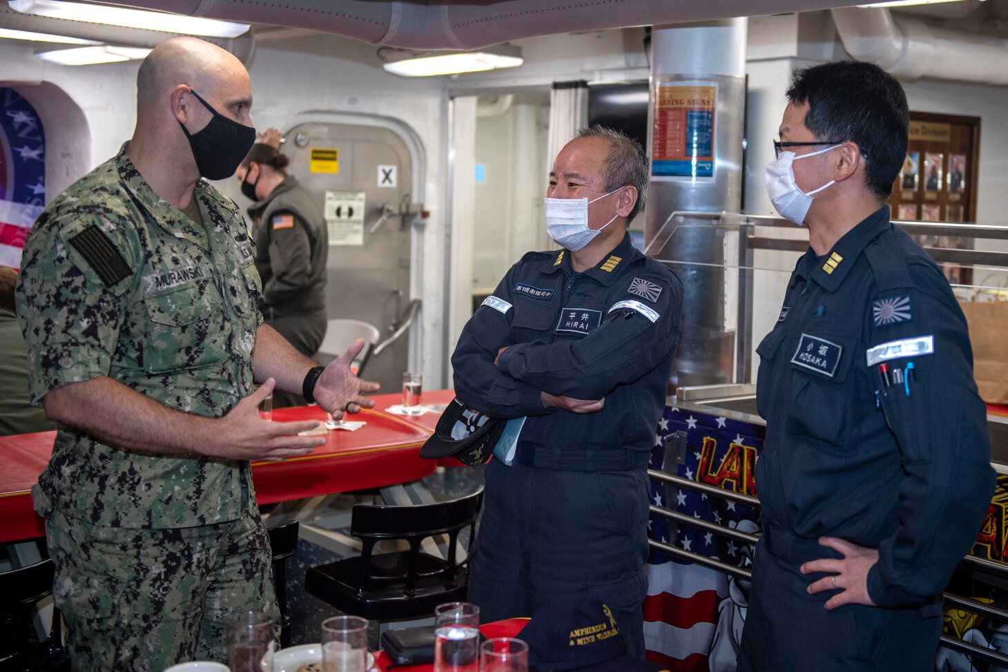 210703-N-HG846-1267 SYDNEY (July 3, 2021) – Cmdr. J.J. Murawski (left), commanding officer of the Arleigh Burke-class guided-missile destroyer USS Rafael Peralta (DDG 115), meets with representatives from the Japan Maritime Self Defense Force to discuss joint maritime operations during Pacific Vanguard 2021. Pacific Vanguard, an exercise involving U.S., Australian, Republic of Korea navies and Japan Maritime Self Defense Force, is designed to strengthen maritime operations in the multilateral environment. (U.S. Navy photo by Mass Communication Specialist 3rd Class Daniel Serianni)