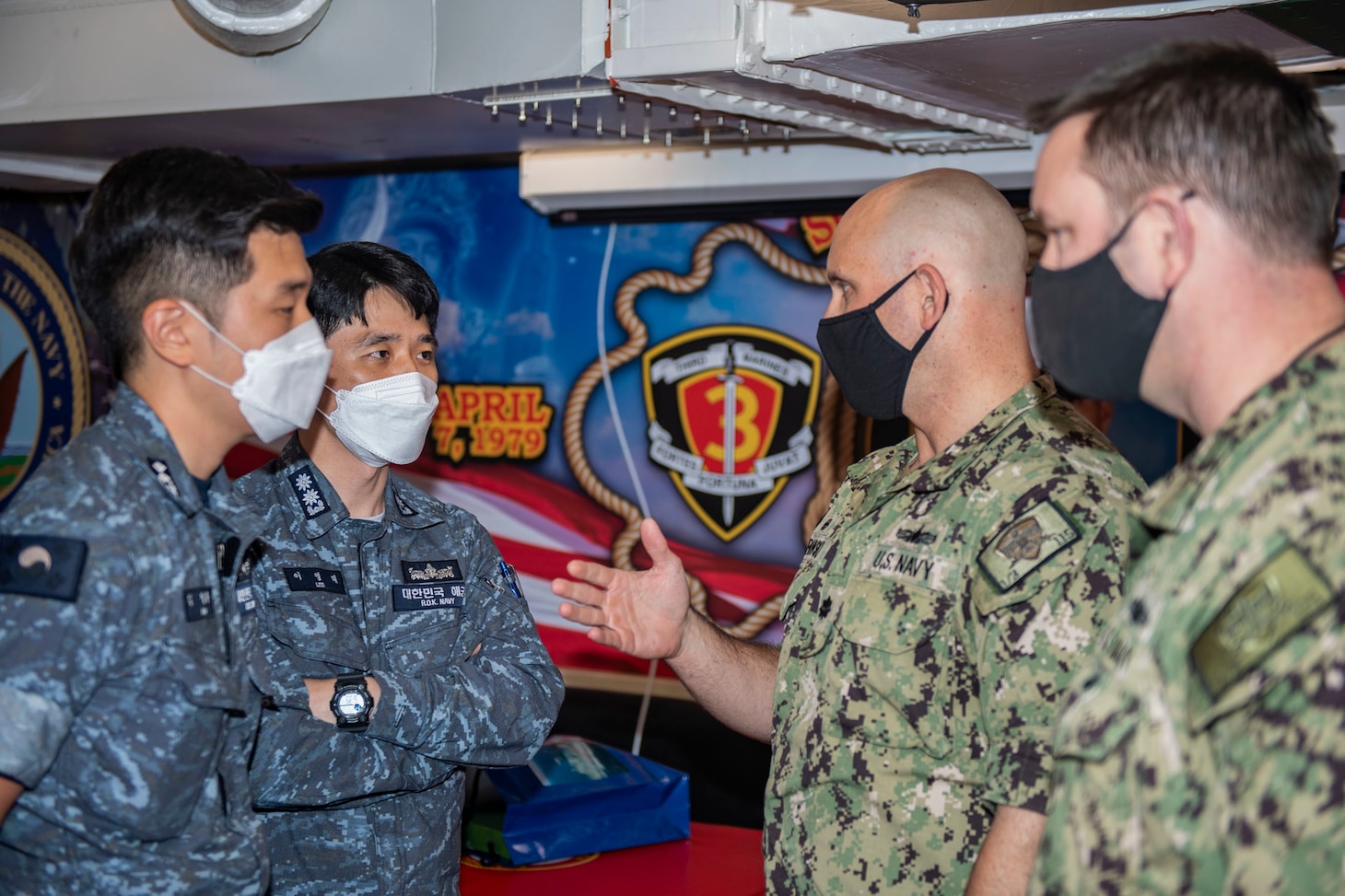 210703-N-HG846-1319 SYDNEY (July 3, 2021) – Cmdr. J.J. Murawski (left), commanding officer of the Arleigh Burke-class guided-missile destroyer USS Rafael Peralta (DDG 115), and Cmdr. Charles Cooper (right), executive officer, meet with officers from the Republic of Korea to discuss joint maritime operations during Pacific Vanguard. Pacific Vanguard, an exercise involving U.S., Australian, Republic of Korea navies and Japan Maritime Self Defense Force, is designed to strengthen maritime operations in the multilateral environment. (U.S. Navy photo by Mass Communication Specialist 3rd Class Daniel Serianni)