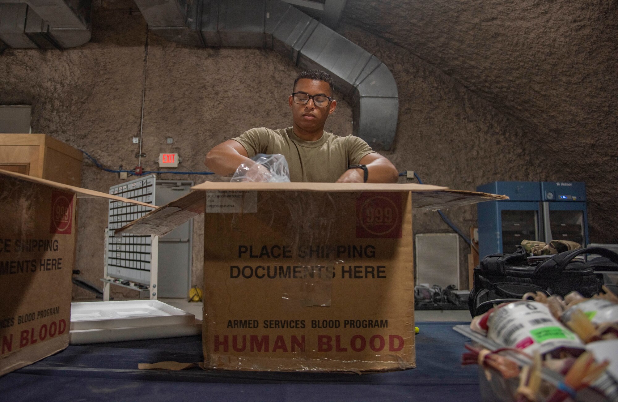 Staff Sgt. Cullen Sullivan, 379th Expeditionary Medical Support Squadron medical laboratory technician, packs ice over blood products to keep them cool July 1, 2021, at Al Udeid Air Base, Qatar.