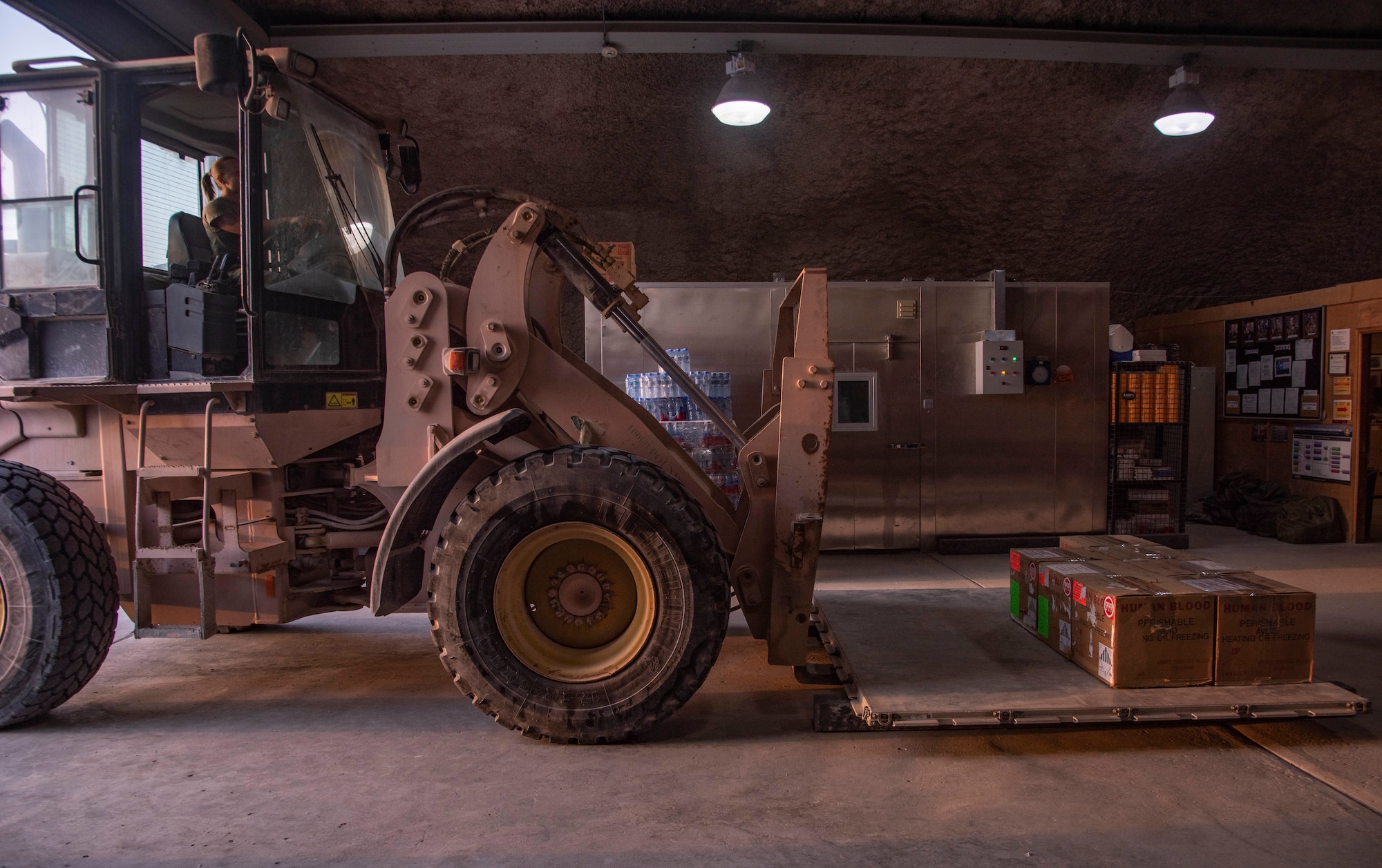 Staff Sgt. Rachel Rhoads, 379th Expeditionary Medical Support Squadron blood transshipment center NCO in charge, prepares to move a pallet of packaged blood products July 1, 2021, at Al Udeid Air Base, Qatar.