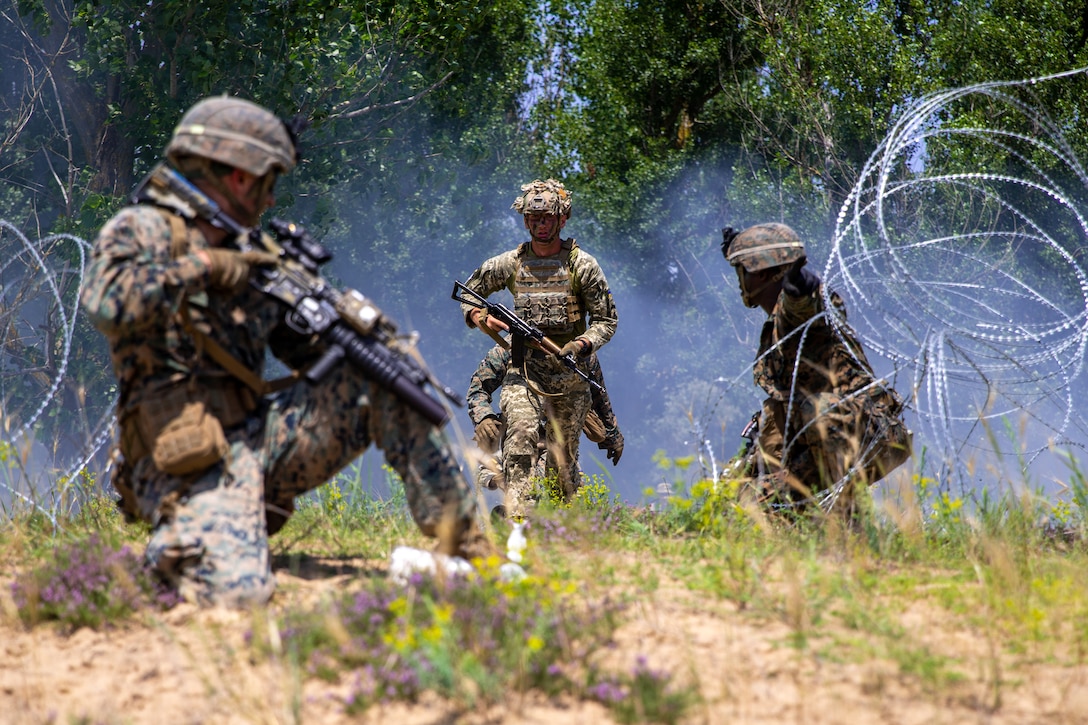 Ukrainian Armed Forces Cpl. Vasil Boichenko, a paratrooper cadet with the Odesa Military Academy, runs through smoke concealment towards a breached obstacle during Exercise Sea Breeze 21 in a nondisclosed location on July 2, 2021. Exercise Sea Breeze is an annual event that brings together military units from several countries, and within 2d Marine Expeditionary Force, to enhance their warfighting capabilities and build strong relationships. (U.S. Marine Corps photo by Lance Cpl. Jacqueline Parsons)