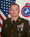 man standing in front of flag.