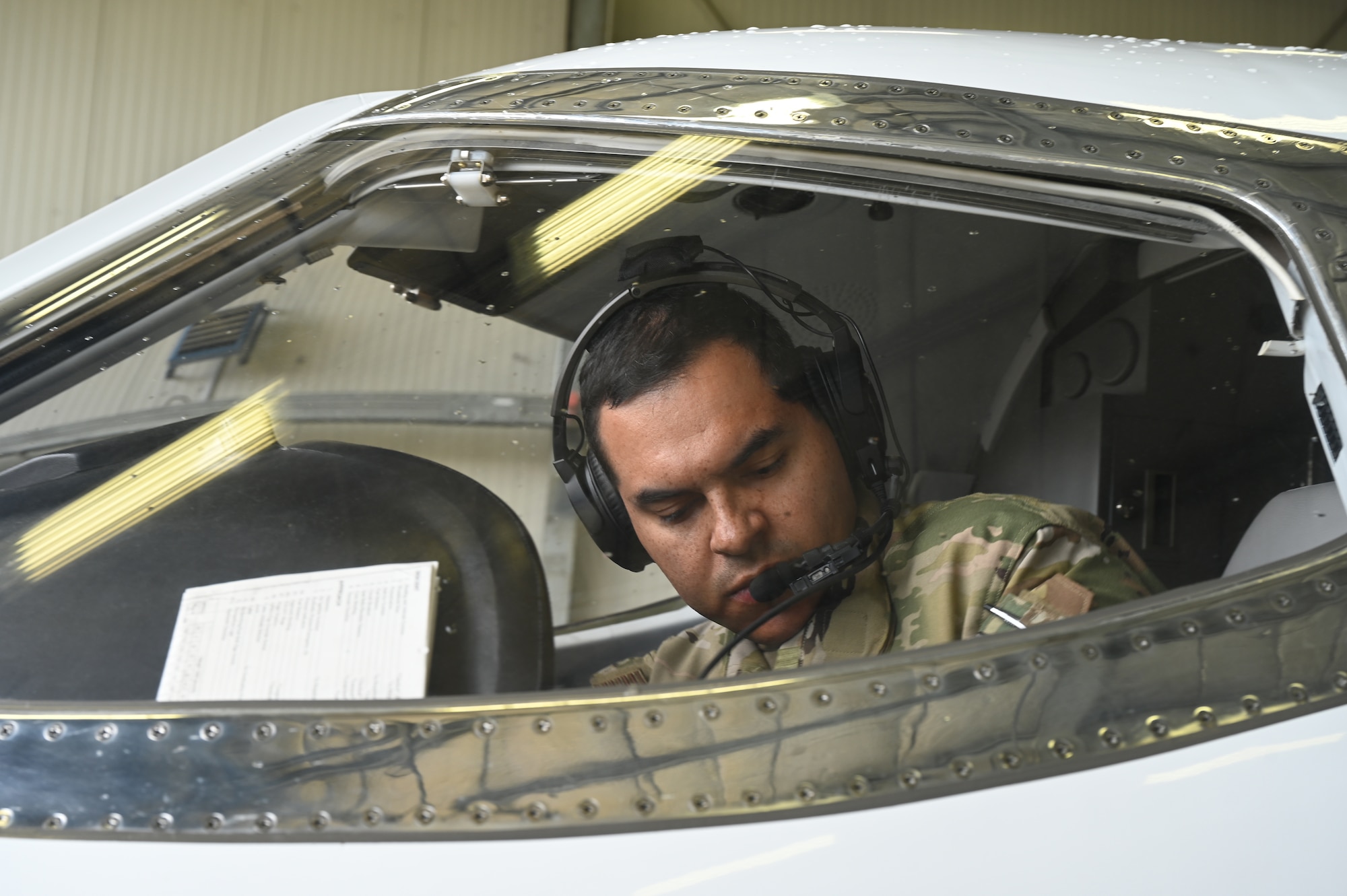 U.S Air Force Maj. Luis Garces, United States Air Forces in Europe standards and evaluations officer, performs pre-flight checks on a C-21aircraft assigned to the 76th Airlift Squadron at Ramstein Air Base, Germany, July 8 2021. The 76th Airlift Squadron transports high ranking military and civilian officials across and outside the European theater to conduct business on behalf of the U.S. military. (U.S. Air Force photo by Senior Airman Thomas Karol)
