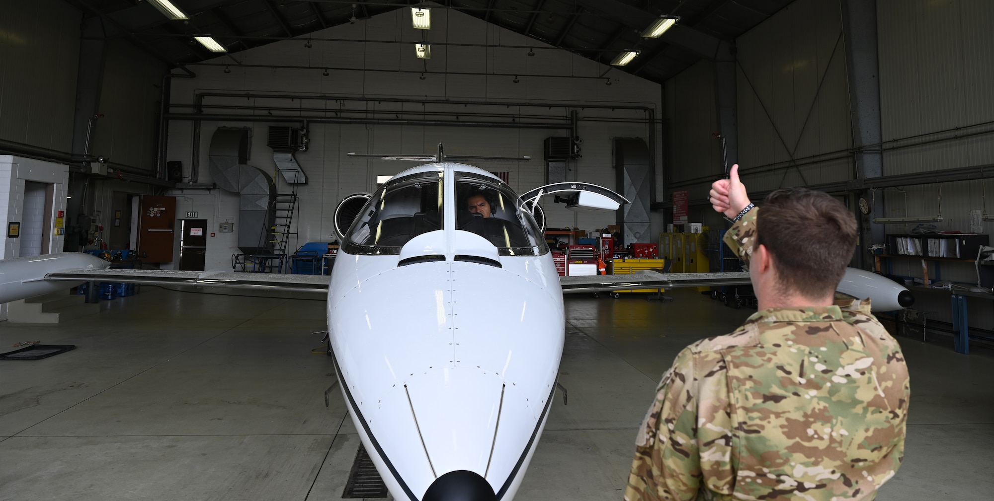 U.S. Air Force Maj. Michael Booth, 76th Airlift Squadron chief executive officer, gives a thumbs-up to Maj. Luis Garces, United States Air Forces in Europe standards and evaluations officer, during pre-flight checks at Ramstein Air Base, Germany, July 8, 2021. The 76th Airlift Squadron transports high ranking military and civilian officials across the European theater and to hotspot locations on behalf of the U.S. military. (U.S. Air Force photo by Senior Airman Thomas Karol)