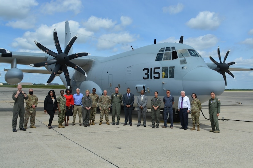 JOINT BASE ANDREWS, Md. - Col. Tyler Schaff, 316th Wing and Joint Base Andrews commander, U.S. Navy Capt. Eddie Pilcher, Naval Air Facility Washington’s commanding officer, and members of the Navy Operational Support Center, Washington, D.C.’s Fleet Logistics Support Squadron 53, pose with Joint Base Andrews honorary commanders on the flightline during the Honorary Commanders Program quarterly visit at JBA, Md., June 25, 2021. The JBA Honorary Commanders Program matches a civic leader with a military leader to provide commanders a means to educate participants about the armed forces and their various missions. (U.S. Air Force courtesy photo)