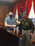 Army applicant Victor Bassett shakes hands with World War II veteran Dennis Thompson during his enlistment ceremony at Sacramento MEPS