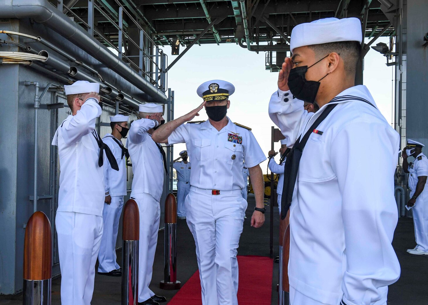 (July 8, 2021) Rear Admiral Ben Reynolds, Director of Maritime Headquarters, U.S. Naval Forces 6th Fleet, walks through the side boys after receiving a tour aboard the Expeditionary Sea Base USS Hershel “Woody” Williams (ESB 4) in the Atlantic Ocean, July 8, 2021. Hershel “Woody” Williams is on a scheduled deployment in the U.S. Sixth Fleet area of operations in support of U.S. national interests and security in Europe and Africa.