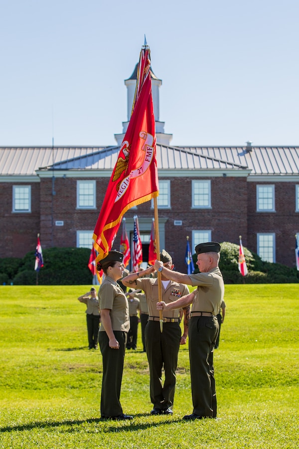 U.S. Marine Col. Brian W. Mullery, left, passes the regimental colors to Col. Lauren S. Edwards during a change of ceremony on June 18, 2021, at Camp Lejeune, North Carolina. During the ceremony, Col. Lauren S. Edwards, took command of Combat Logistics Regiment 27 from Col. Brian W. Mullery. (U.S. Marine Corps photo by Lance Cpl. Scott Jenkins)