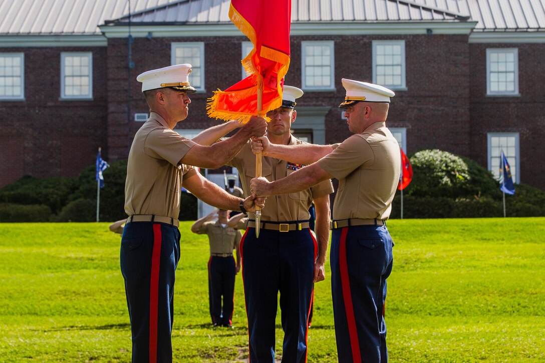 U.S. Marine Corps Lt. Col. James D. Thornburg Jr., right, outgoing commanding officer of Combat Logistics Battalion 22 (CLB-22), passes the battalion colors to Lt. Col. Luke A. Sauber, commanding officer, CLB-22, during a change of command ceremony on Camp Lejeune, North Carolina, July 1, 2021. During the ceremony, Lt. Col. James D. Thornburg Jr. relinquished command to Lt. Col. Sauber. (U.S. Marine Corps photo by Lance Cpl. Zachary Zephir)