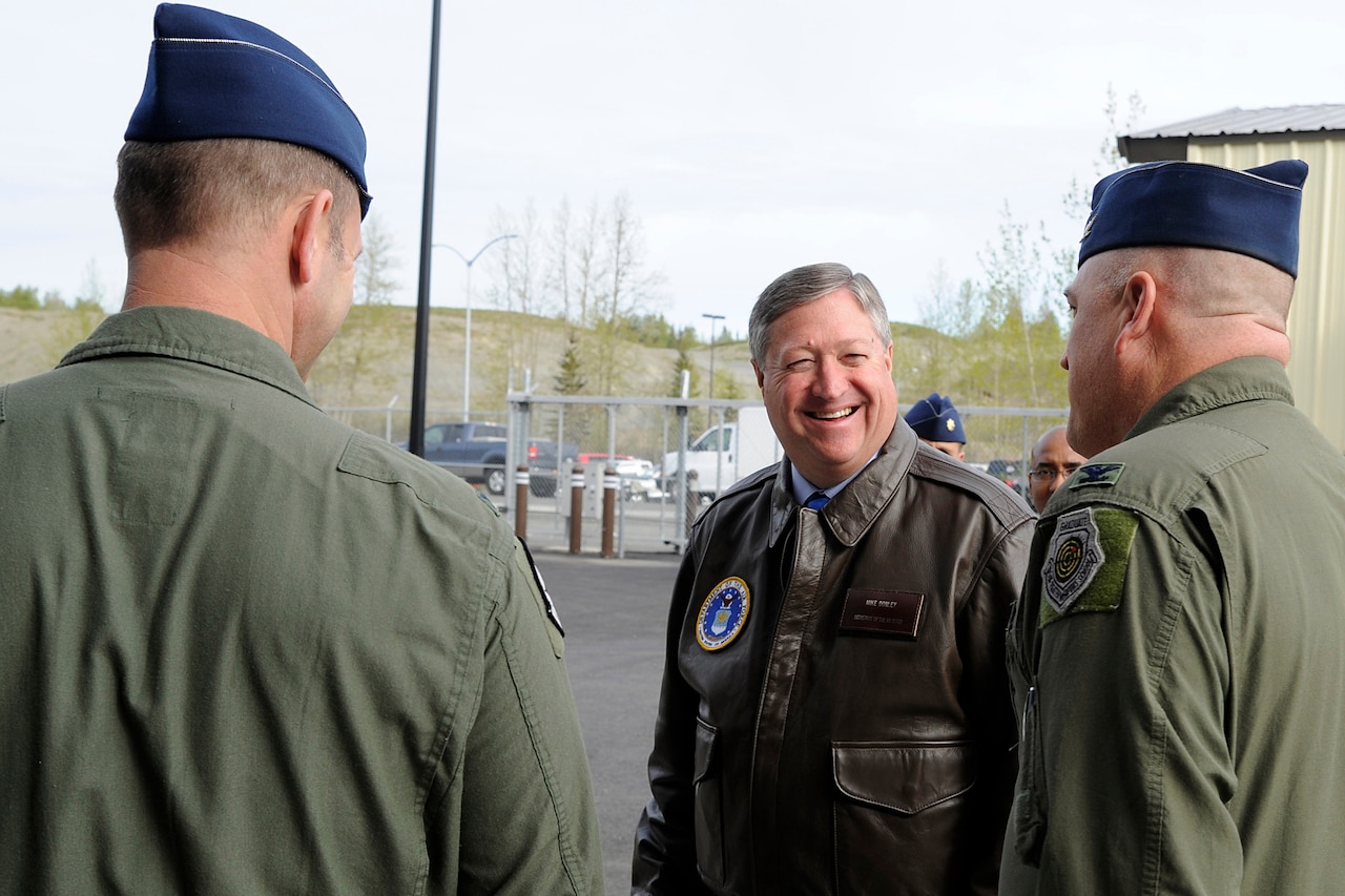 A man speaks to military personnel.