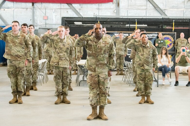 A formation of Airmen gives Maj. Shawn Cox his first salute as commander during the 736th Aircraft Maintenance Squadron Change of Command ceremony at Dover Air Force Base, Delaware, July 9, 2021. The ceremony saw Lt. Col. Kevin Scholzrelinquish command to Cox. The squadron is responsible for the inspection, repair, launch and recovery of eight C-17 Globemaster III aircraft. (U.S. Air Force photo by Mauricio Campino)