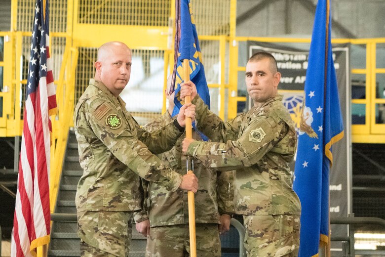 Col. Bary Flack, left, 436th Maintenance Group commander, passes the guidon to Maj. Shawn Cox, incoming 736th Aircraft Maintenance Squadron commander, during a change of command ceremony at Dover Air Force Base, Delaware, July 9, 2021. The ceremony saw Lt. Col. Kevin Scholz relinquish command to Cox. The squadron is responsible for the inspection, repair, launch and recovery of eight C-17 Globemaster III aircraft. (U.S. Air Force photo by Mauricio Campino)