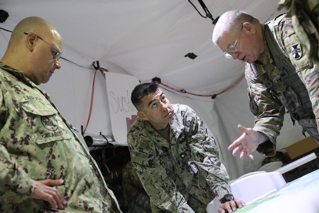 412th TEC Soldiers plan out scenarios during annual summer exercise at Schofield Barracks on 21 June.