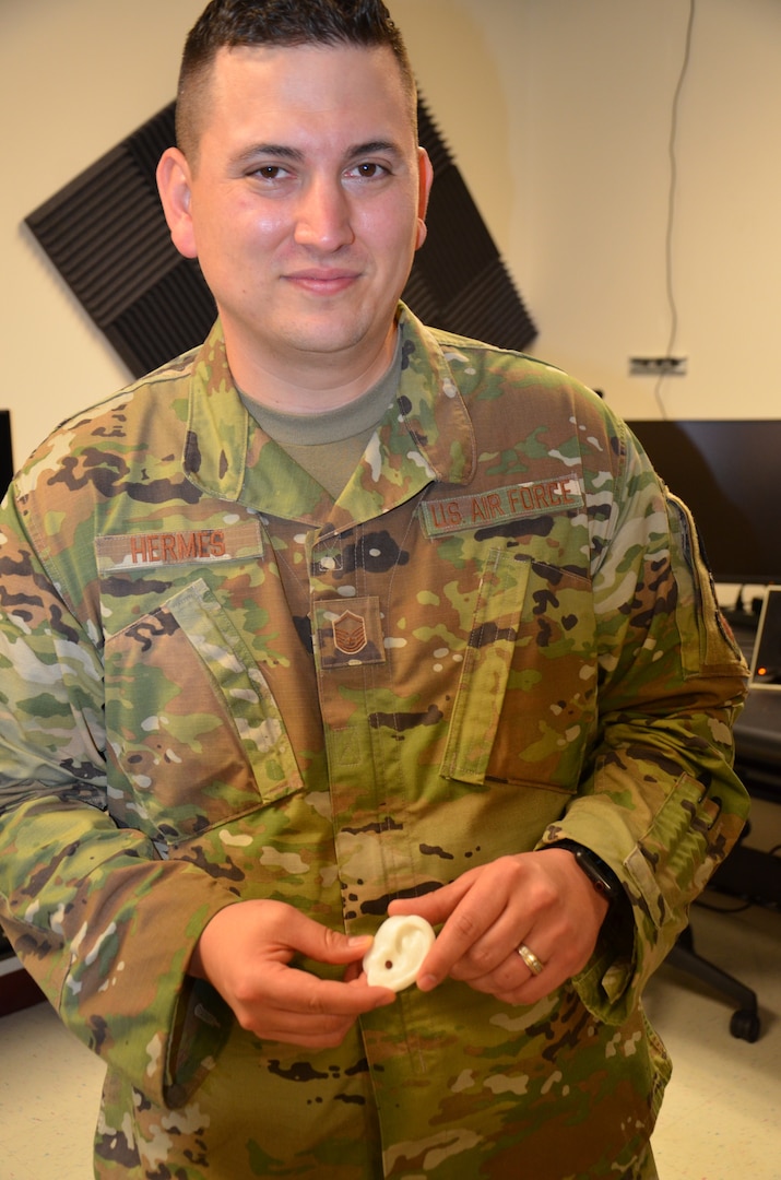 Air Force Master Sgt. Brian Hermes, an instructor in the METC Radiologic Technologist program and leader of the Alamo Spark cell, displays a simulated ear designed by Alamo Spark members for combat acupuncture training.