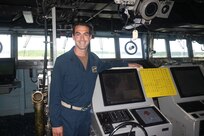 Lt. Clint McNutt, navigator on the dock landing ship USS Whidbey Island (LSD 41), poses near the ship’s helm. McNutt tied with Seaman Kelly House, assigned to Assault Craft Unit Two, for top score in the ship-handling competition during Surface Line Week 2021. (U.S. Navy courtesy photo/Released)