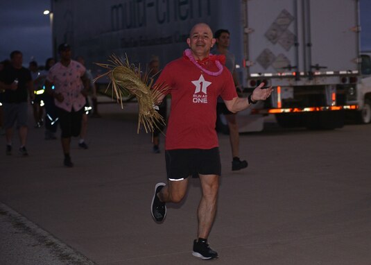 U.S. Air Force Col. Andres Nazario, 17th Training Wing commander, runs during the NAZA-PA-LUAU Wing Fun Run on Goodfellow Air Force Base, July 9, 2021. The run totaled at 1.7 miles to honor the “17” in 17th TRW. (U.S. Air Force photo by Senior Airman Ashley Thrash)
