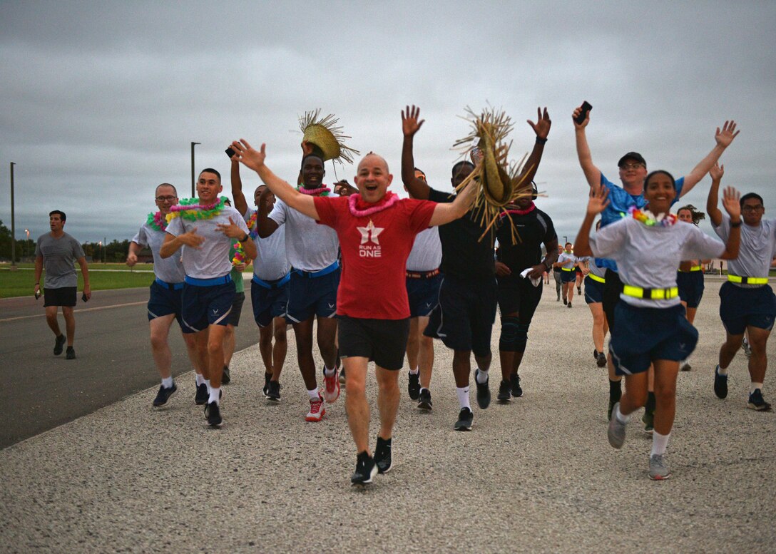 U.S. Air Force Col. Andres Nazario, 17th Training Wing commander, and members of the 17th TRW run towards the finish line at the NAZA-PA-LUAU Wing Fun Run on Goodfellow Air Force Base, July 9, 2021. The run commemorated Nazario’s last engagement with the base community before heading to the Pentagon in Washington, D.C. (U.S. Air Force photo by Senior Airman Ashley Thrash)