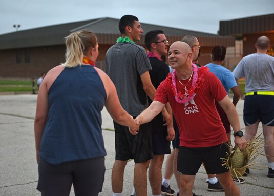 U.S. Air Force Col. Andres Nazario, 17th Training Wing commander, thanks 17th TRW members at the NAZA-PA-LUAU Wing Fun Run on Goodfellow Air Force Base, July 9, 2021. The NAZA-PA-LUAU consisted of a 1.7 mile run around the Fire Academy and breakfast burritos after members passed the finish line. (U.S. Air Force photo by Senior Airman Ashley Thrash)