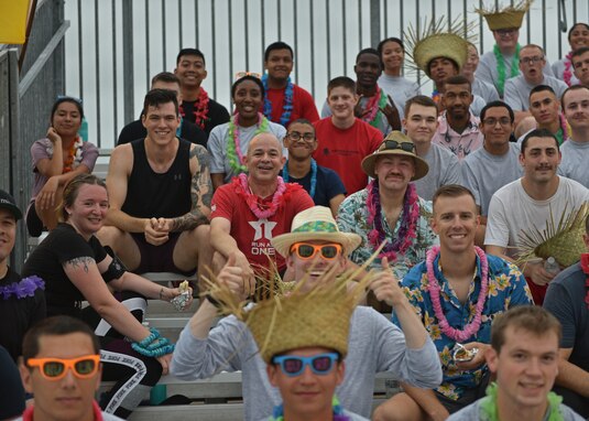 U.S. Air Force Col. Andres Nazario, 17th Training Wing commander, poses with members of the 17th TRW at the NAZA-PA-LUAU Wing Fun Run on Goodfellow Air Force Base, July 9, 2021. Members attending celebrated in Hawaiian-themed attire. (U.S. Air Force photo by Senior Airman Ashley Thrash)