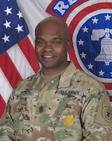 man standing in front of flags.