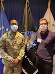 Capt. Preston Giddens, New York MEPS operations officer, presiding officer for the Oath of Enlistment with new recruit Fernando Lopez