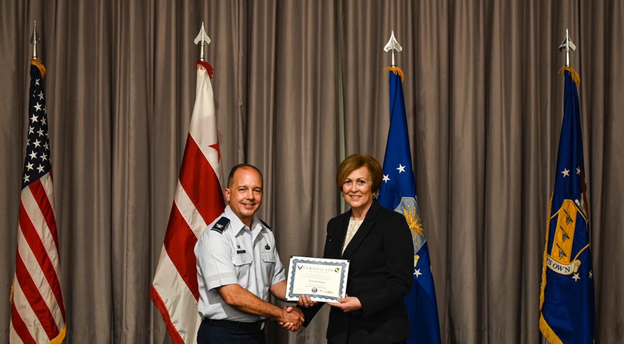 Col. Don Schofield, Commander and Conductor of The U.S. Air Force Band, confers the title of Honorary Commander of The U.S. Air Force Band to Deborah Rutter, President of the John F. Kennedy Center for the Performing Arts in Washington, D.C. in a ceremony held at the Bolling Club on May 14, 2021 (U.S. Air Force photo by Senior Airmen Kevin Tanenbaum)