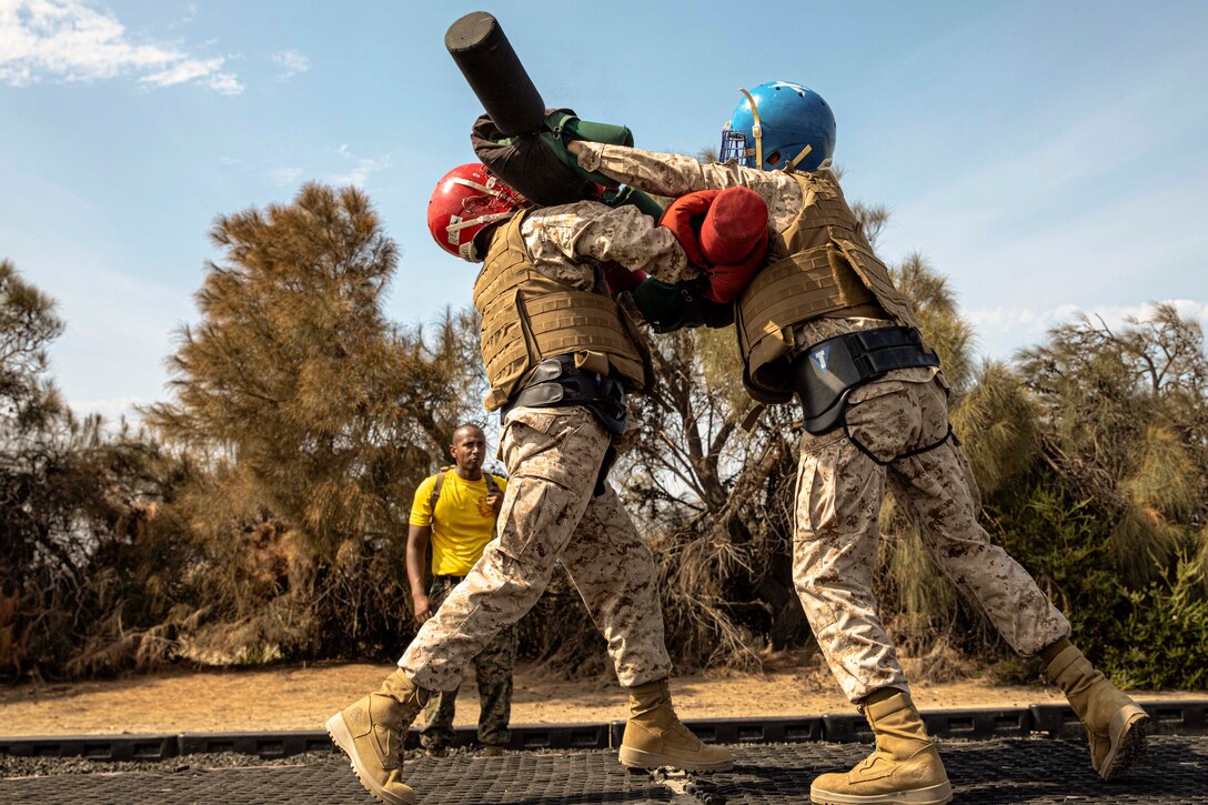 Two Marine Corps recruits compete in a pugil stick event.
