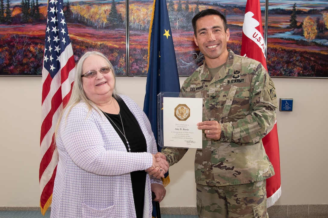Amy Burke, workforce management specialist, receives a 50-year Army Length of Service Award from Col. Damon Delarosa, commander of the U.S. Army Corps of Engineers – Alaska District, during a ceremony on June 24 at Joint Base Elmendorf-Richardson.