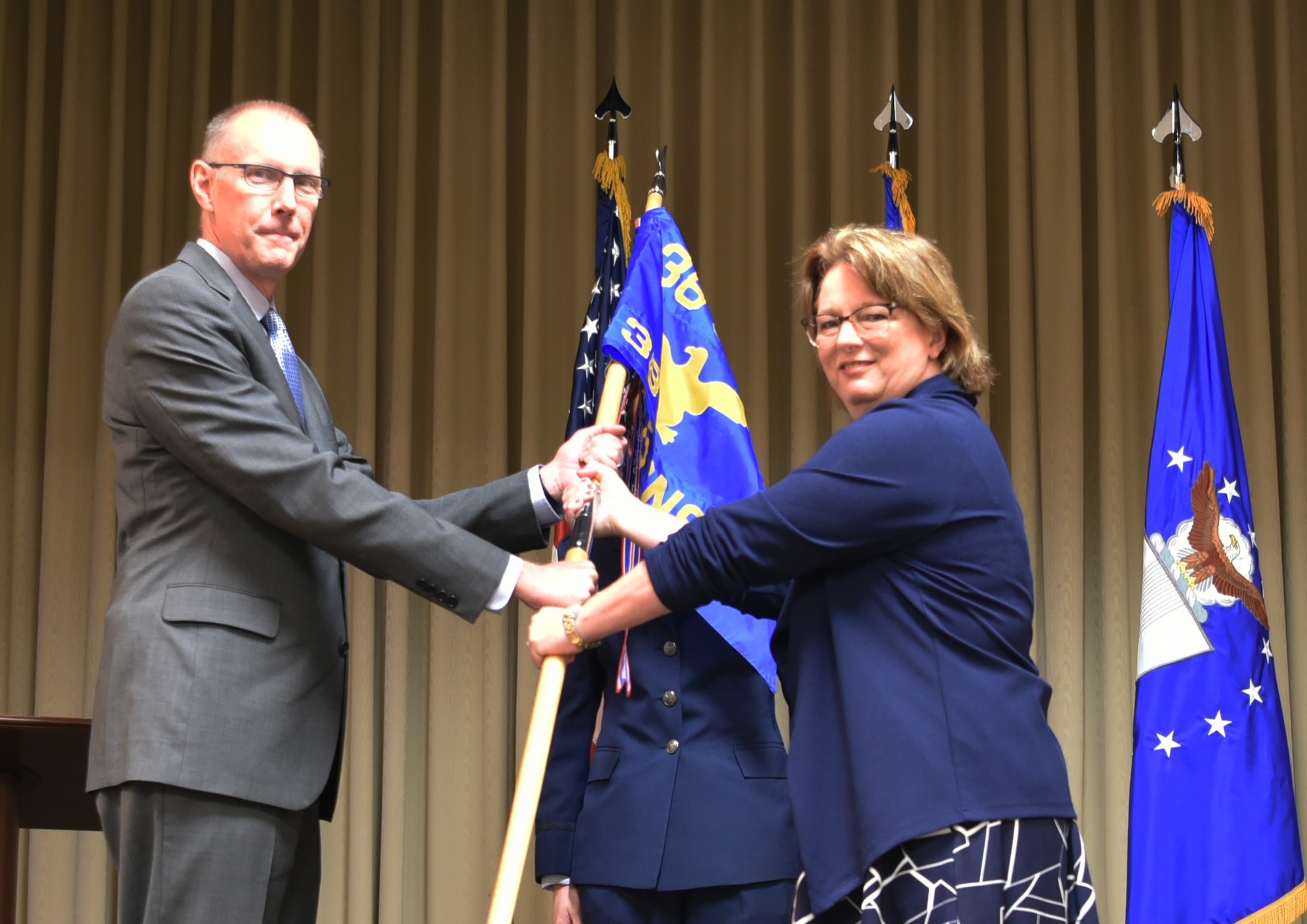 Two people holding a flag