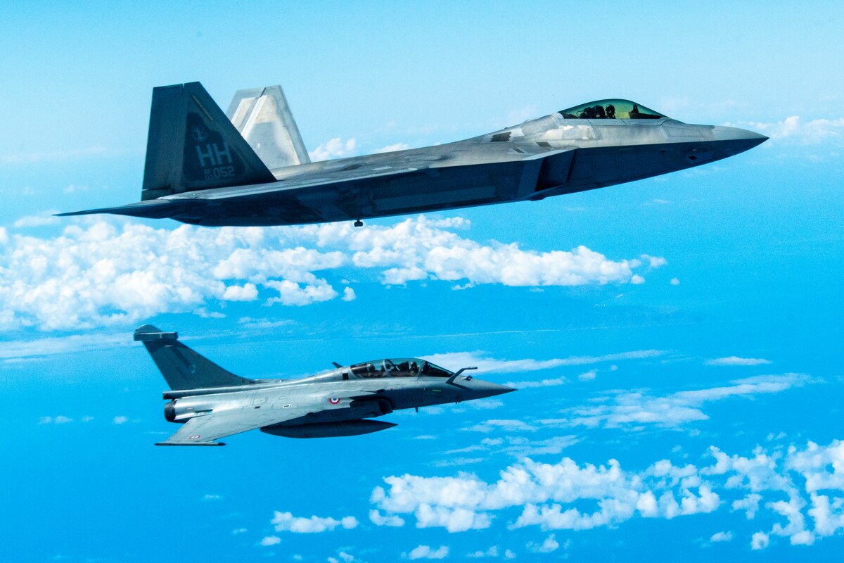 Two fighter jets fly in formation.