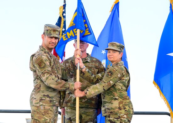 U.S. Air Force Col. Heidi Paulson, incoming 378th Expeditionary Mission Support Group commander, accepts command of the 378th EMSG from Brig. Gen. Robert Davis, 378th Air Expeditionary Wing commander, during the group change of command ceremony, Prince Sultan Air Base, July 5, 2021. The 378th EMSG provides full spectrum support to the 378th AEW and joint partners, sustaining and defending forces to enable combat power projection in the region. (U.S. Air Force photo by Senior Airman Samuel Earick)