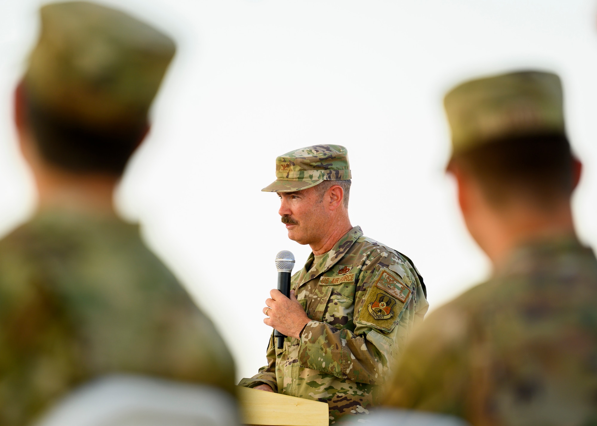 U.S. Air Force Col. David Briggs, outgoing 378th Expeditionary Mission Support Group commander, addresses the crowd during the unit change of command ceremony, Prince Sultan Air Base, July 5, 2021. The 378th EMSG provides full spectrum support to the 378th Air Expeditionary Wing and joint partners, sustaining and defending forces to enable combat power projection in the region. (U.S. Air Force photo by Senior Airman Samuel Earick)