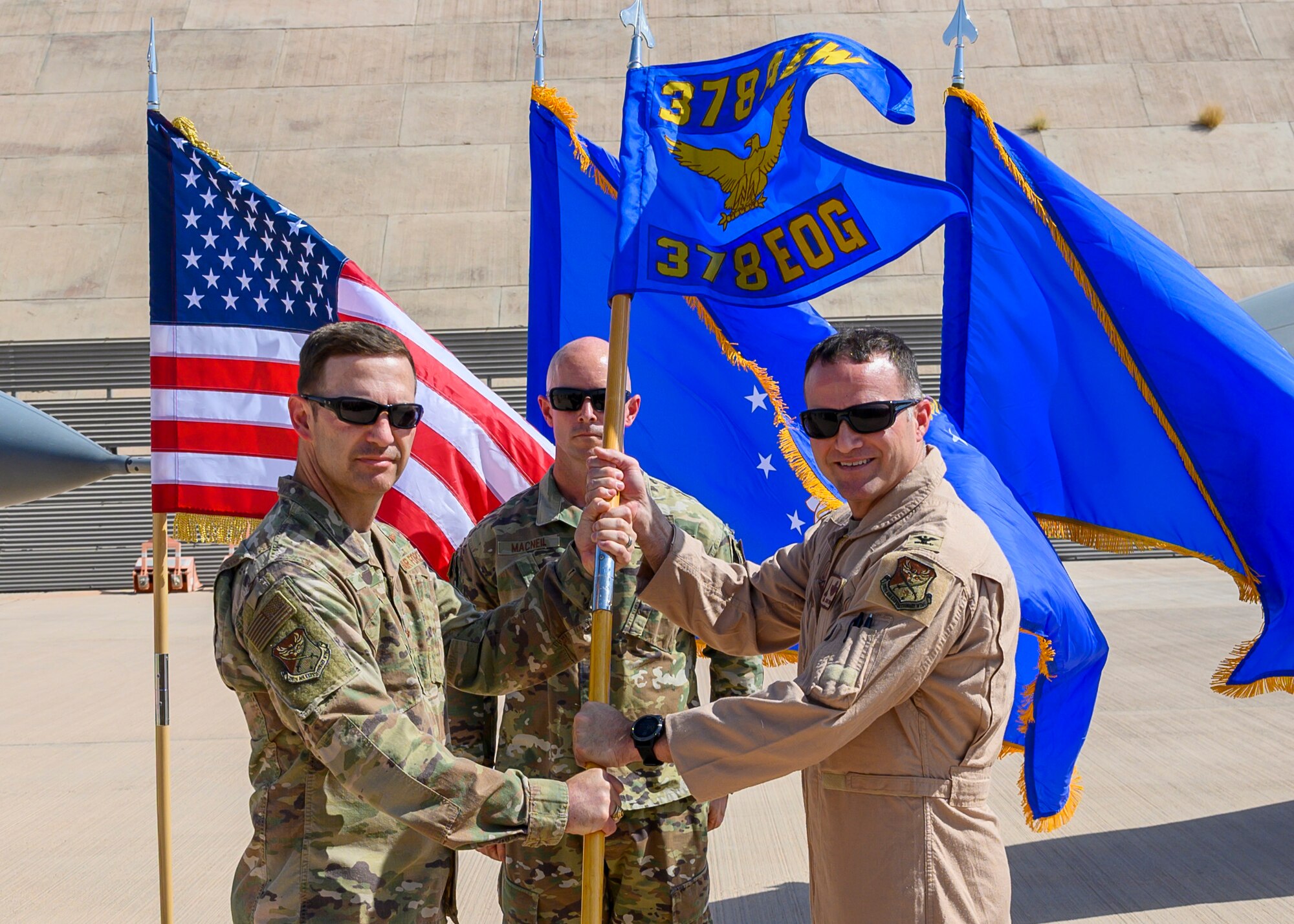 U.S. Air Force Col. Jason “Hollywood” Smith accepts command of the 378th Expeditionary Operations Group from Brig. Gen. Robert Davis, 378th Air Expeditionary Wing commander, during the group change of command, Prince Sultan Air Base, July 5, 2021. The 378th EOG provides combat power projection in support of U.S. Central Command plans and operations. (U.S. Air Force photo by Senior Airman Samuel Earick)
