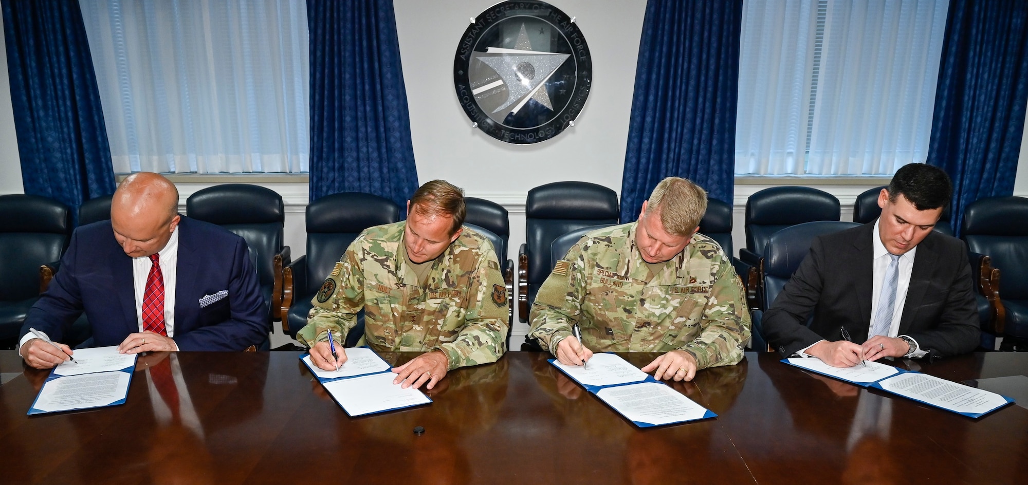 Robert Preston, Judge Advocate General’s Corps, Civil Law Domain director; Maj. Gen. Cameron Holt, Office of the Assistant Secretary of the Air Force for Acquisition, Contracting deputy assistant secretary; Brig. Gen. Terry Bullard, Air Force Office of Special Investigations commander; and Derek Santos, Contractor Responsibility and Conflict Resolution deputy general counsel, sign a joint memorandum of understanding at the Pentagon, Arlington, Va., July 8, 2021. The MOU established the Department of the Air Force Acquisition Integrity Working Group.