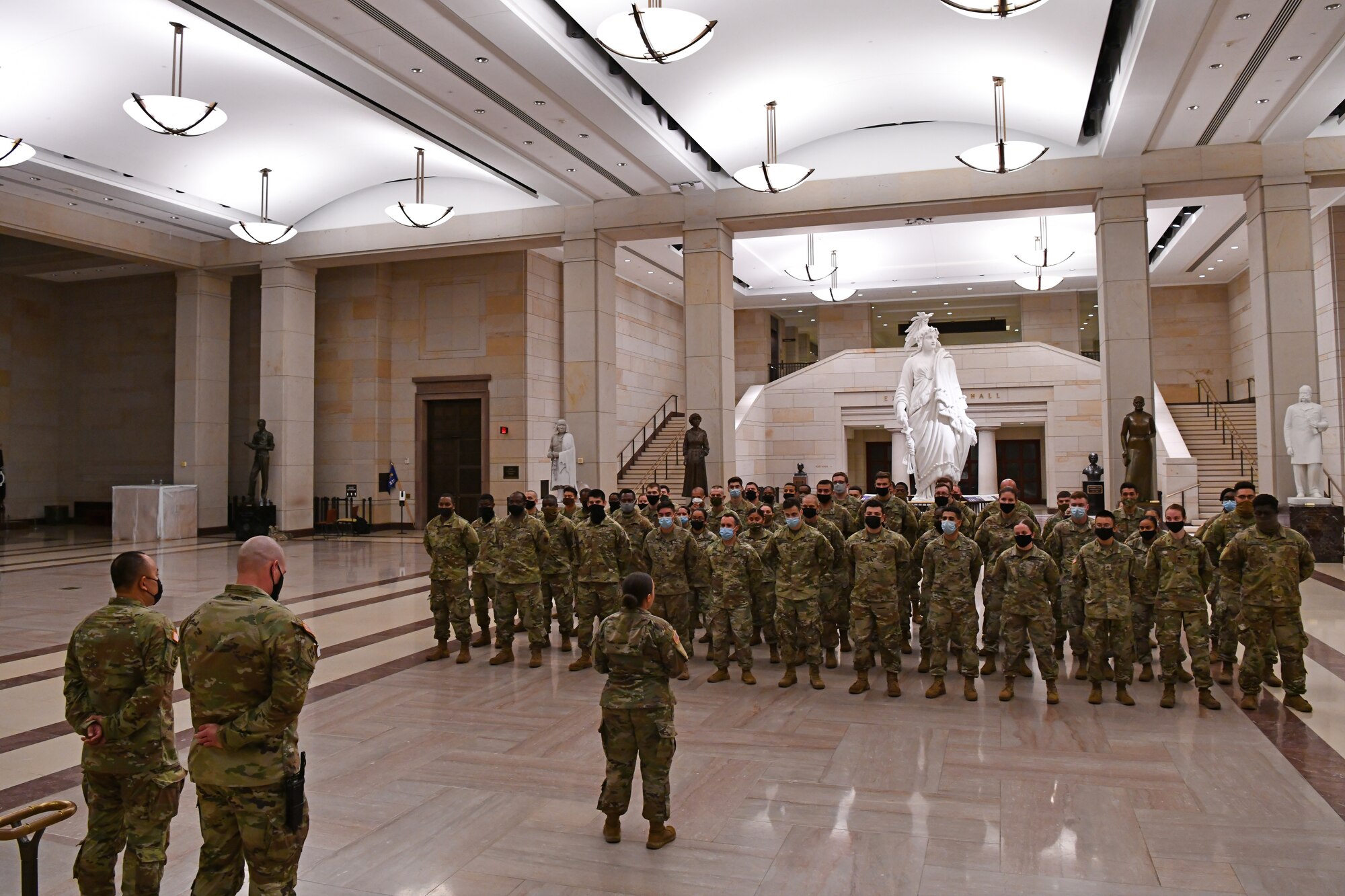 U.S. Army Capt. Tiffany Pelrine, center, 272nd Chemical Company commander with the Massachusetts National Guard, addresses a formation during a combined promotion and award ceremony at the U.S. Capitol building in Washington, D.C., May 21, 2021. The National Guard has been requested to continue supporting federal law enforcement agencies with security, communications, medical evacuation, logistics and safety support to state, district and federal agencies through mid-May. (U.S. Air National Guard photo by Staff Sgt. Hanna Smith)