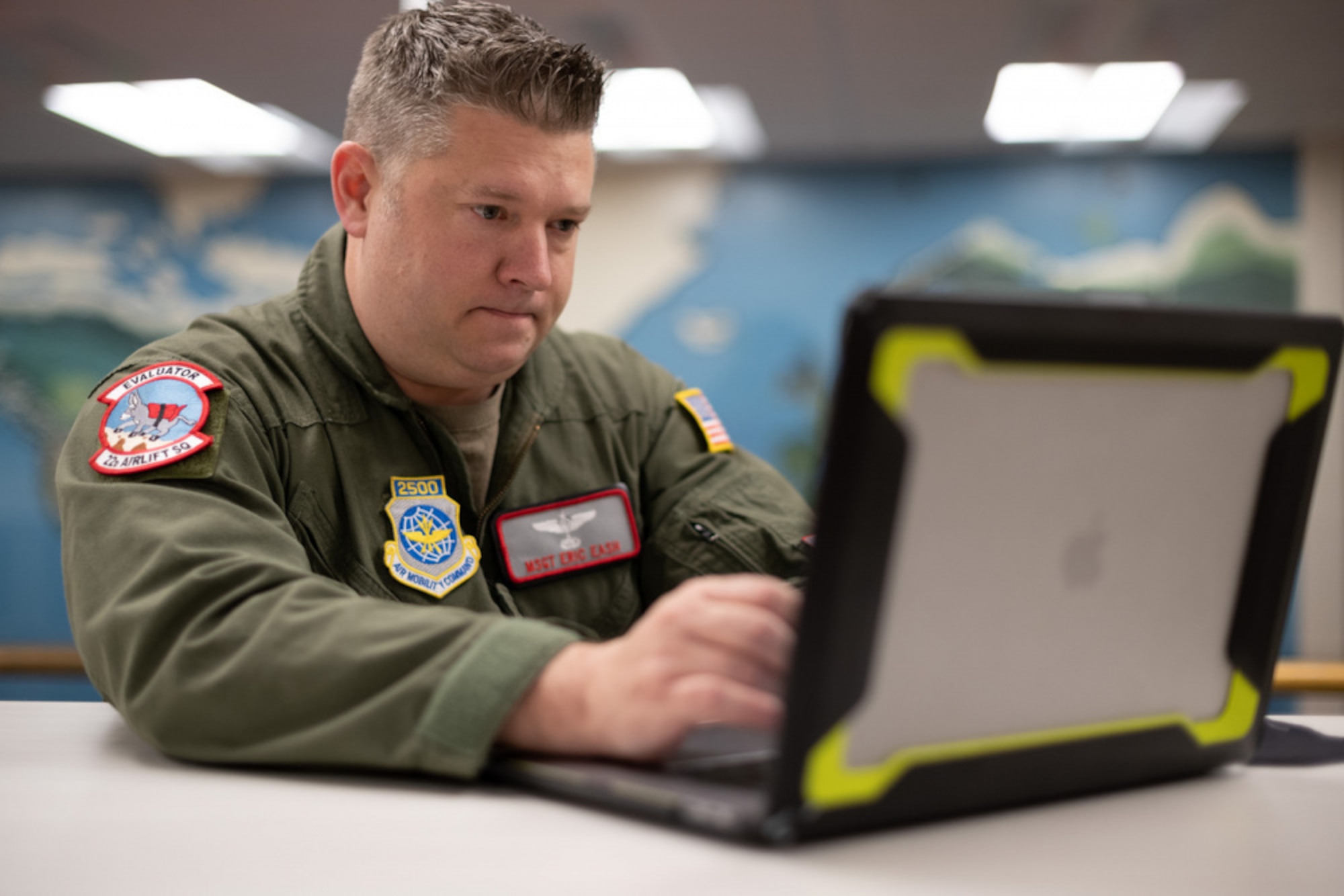 An Airman sitting down at a laptop