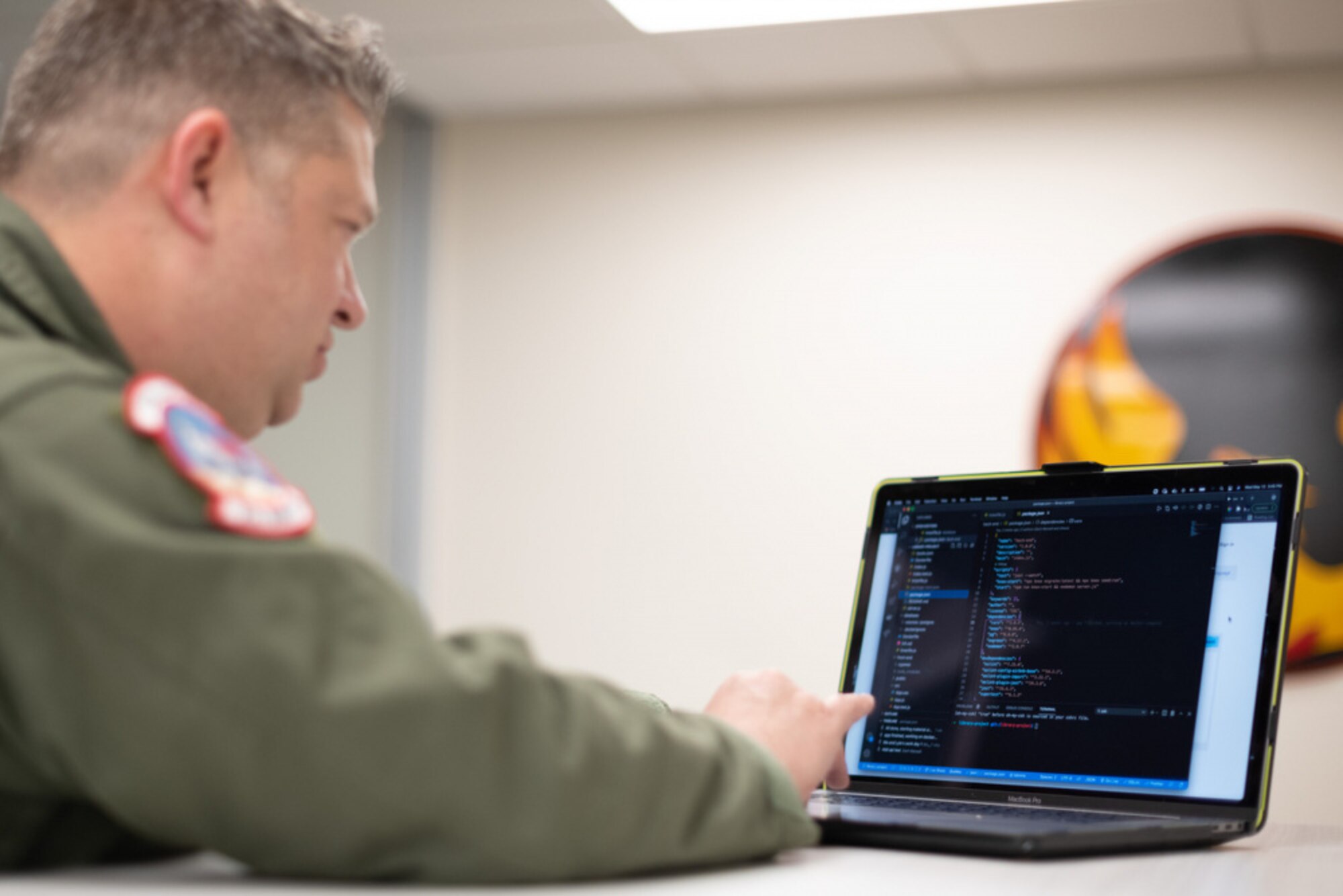 An Airman sitting down at a laptop