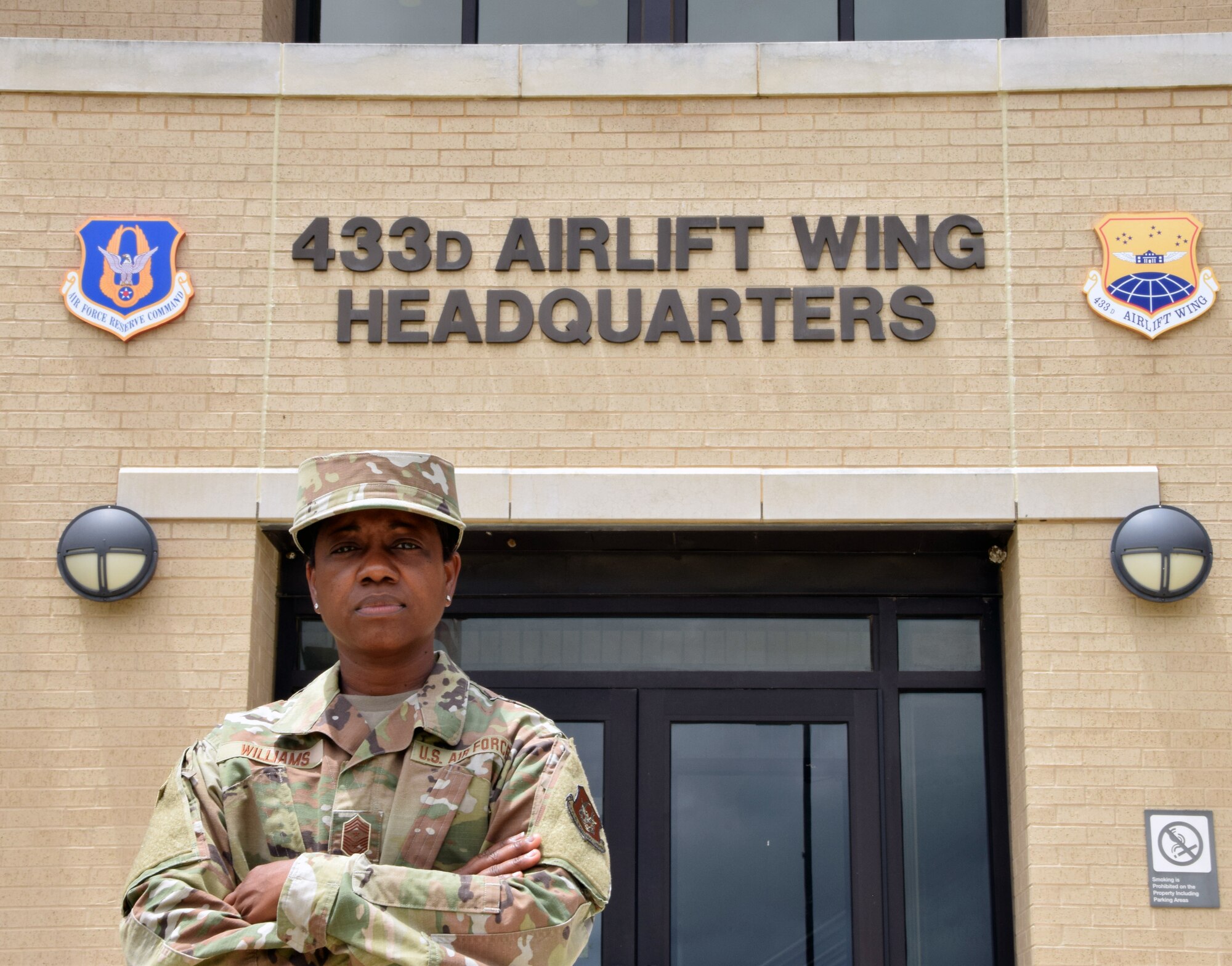 Chief Master Sgt. Takesha Williams, 433rd Airlift Wing Command Chief stands in front of the 433rd AW headquarters building on July 10, 2021 at Joint Base San Antonio-Lackland, Texas. Williams returned to the 433rd AW as she was previously assigned here as a functional administration manager in 2017. (U.S. Air Force Photo by Staff Sgt. Monet Villacorte)