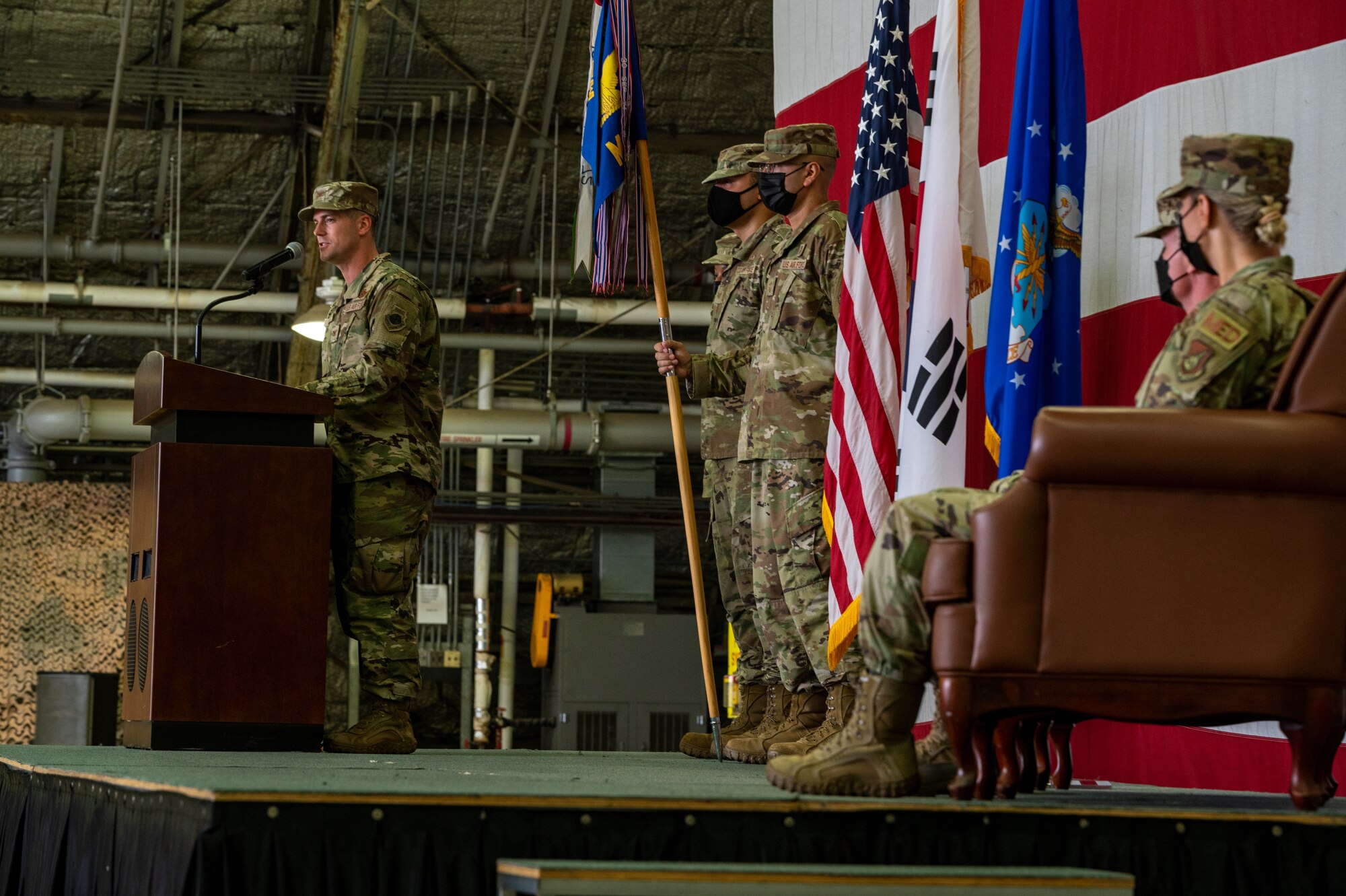 Col. Michael Fea, 51st Medical Group outgoing commander and Col. Jennifer Vecchione, 51st Medical Group incoming commander, listen to opening remarks from Col. Joshua Wood, 51st Fighter Wing commander, left, during the 51st Medical Group change of command ceremony at Osan Air Base, Republic of Korea, July 12, 2021. As the presiding officer, Wood facilitated the transition of 51st MDG command. (U.S. Air Force photo by Tech. Sgt. Nicholas Alder)