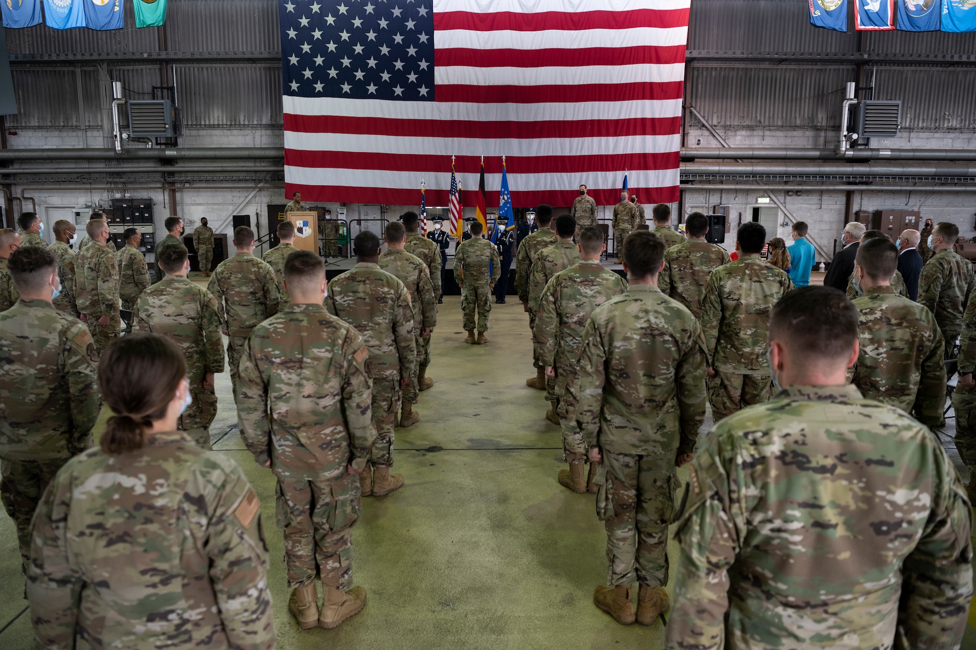 Audience members stand at attention for the playing of the “Star-Spangled Banner” during the 52nd Maintenance Squadron assumption of command ceremony July 9, 2021, on Spangdahlem Air Base, Germany.