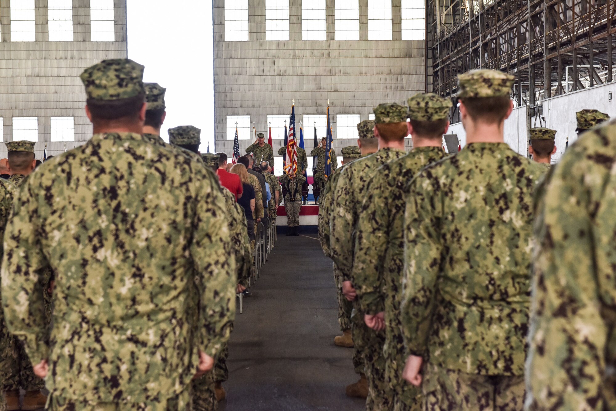 U.S. Navy Sailors stand for the arrival of the official party at the NSA Lakehurst change of command ceremony Joint Base McGuire-Dix-Lakehurst, New Jersey, July 8, 2021. The ceremony was presided over by Rear Adm. Charles Rock, commander of the Navy Region Mid-Atlantic. (U.S. Air Force Photo by Staff Sgt. Shay Stuart)