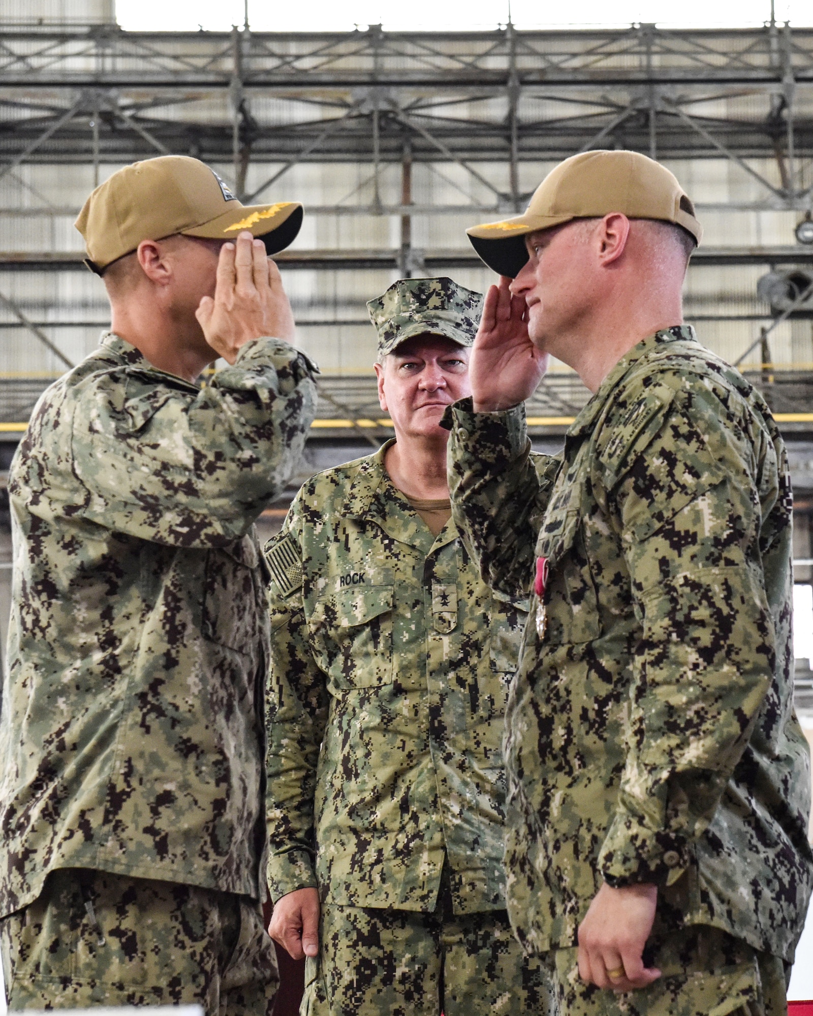 U.S. Navy Capt. William R. Sherrod salutes incoming commander Capt. Frank T. Ingargiola during a change of command ceremony at Joint Base McGuire-Dix-Lakehurst, New Jersey, July 8, 2021. Rear Adm. Charles Rock relieved Sherrod of his orders, allowing Ingargiola to assume command. (U.S. Air Force Photo by Staff Sgt. Shay Stuart)