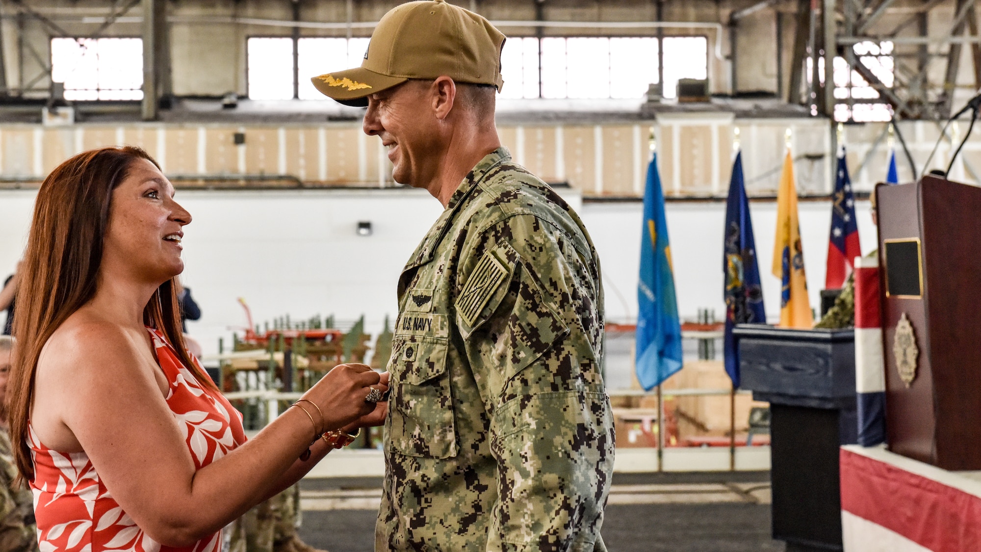 U.S. Navy Capt. Frank T. Ingargiola shares a moment with his wife as she pins him during the change of command ceremony at Joint Base McGuire-Dix-Lakehurst, New Jersey, July 8, 2021. Following the pinning and the assumption of command, Ingargiola gave a speech addressing his new colleagues. (U.S. Air Force Photo by Staff Sgt. Shay Stuart)
