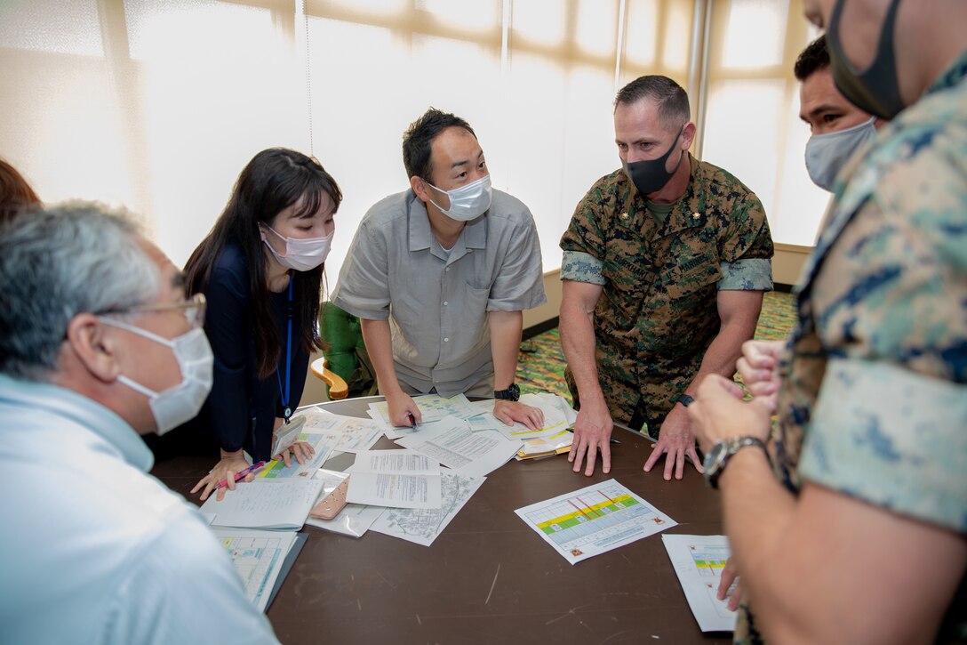 Japanese government officials and U.S. Marines come together for discussions during the Artillery Relocation Training Program Annual Planning Conference on Camp Hansen, Okinawa, Japan, June 22, 2021. The ARTP Annual Conference allows Japanese and U.S. officials to develop a better understanding of the goals of the program, as well as solidify bilateral objectives related to the training, the continued usage of training areas and the modernization of both forces.