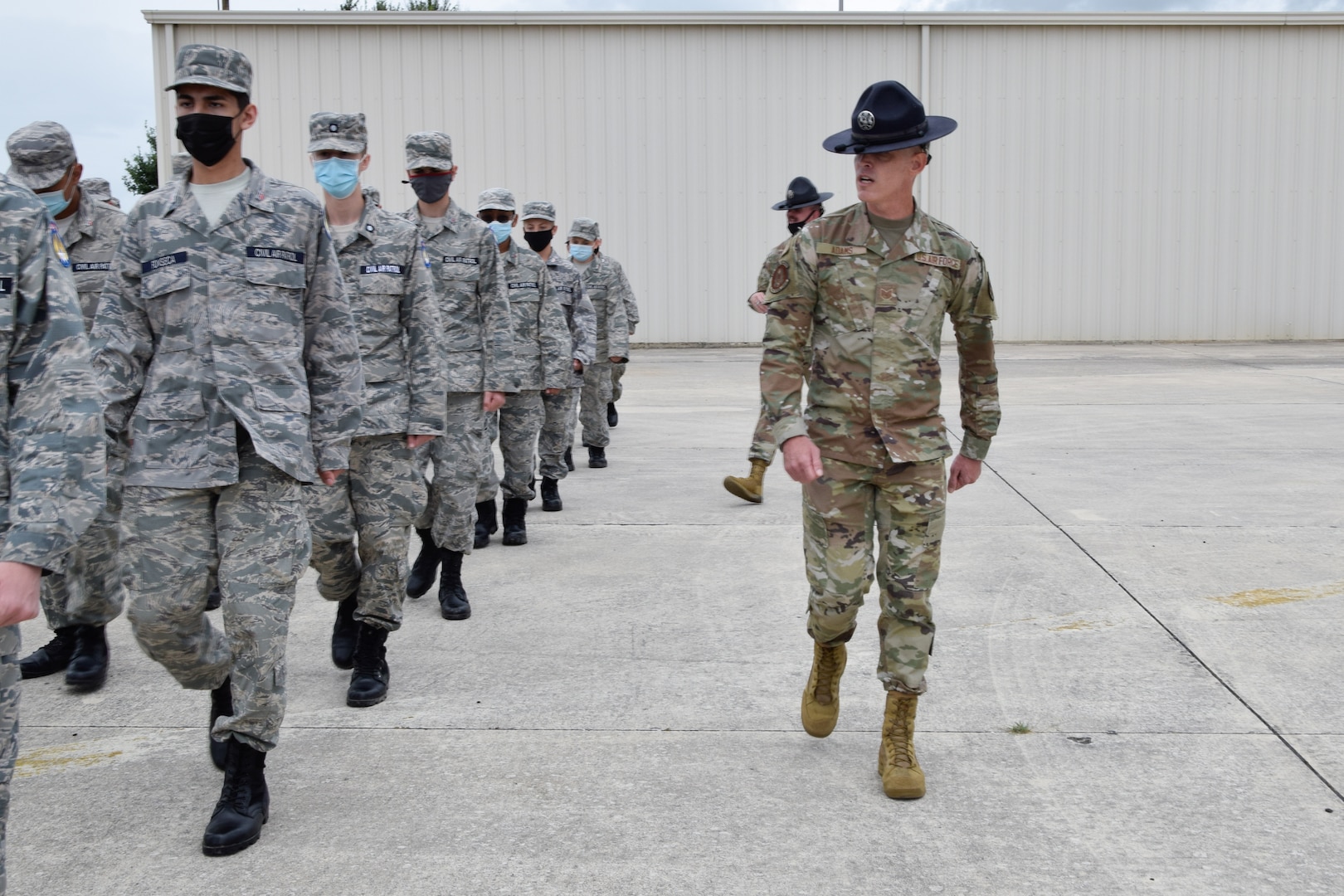 Tech Sgt. Brian Adams, 433rd Training Squadron military training instructor, marches a flight of Texas Wing Civil Air Patrol cadets at Joint Base San Antonio-Lackland, Texas, July 8, 2021. Cadets visited the 433rd Airlift Wing, where they toured a C-5M Super Galaxy aircraft and the engine repair shop. (U.S. Air Force photo by Senior Airman Brittany Wich)